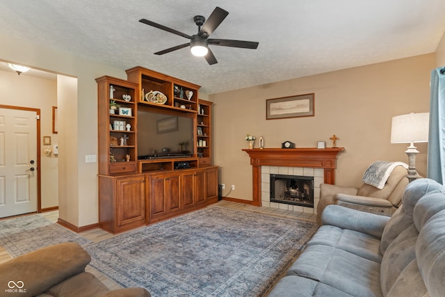 7978 Park Meadows Dr, Brownsburg, IN 46112 - living area featuring ceiling fan, light wood-type flooring, a fireplace, baseboards, and a textured ceiling