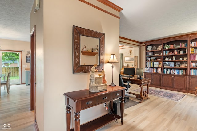 7978 Park Meadows Dr, Brownsburg, IN 46112 - office area featuring light wood-style floors, a textured ceiling, and crown molding