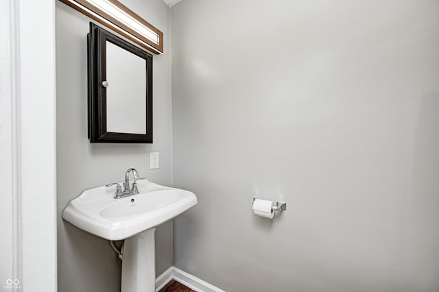 4621 E 17th St, Indianapolis, IN 46218 - bathroom with baseboards and wood finished floors