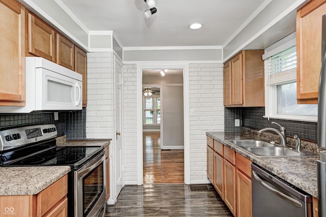 4621 E 17th St, Indianapolis, IN 46218 - kitchen with appliances with stainless steel finishes, a sink, plenty of natural light, tasteful backsplash, and ornamental molding