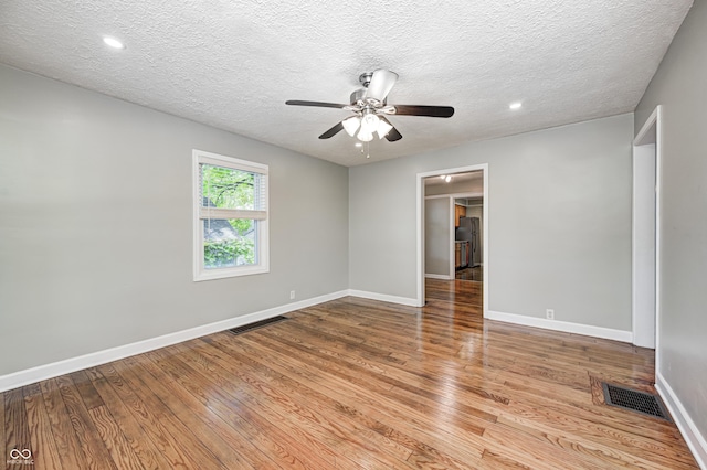 4621 E 17th St, Indianapolis, IN 46218 - empty room featuring a ceiling fan, light wood-style flooring, baseboards, a textured ceiling, and recessed lighting