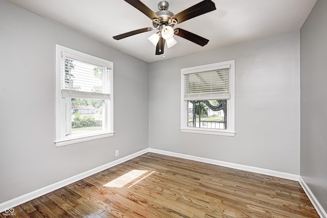 4621 E 17th St, Indianapolis, IN 46218 - spare room featuring baseboards, wood finished floors, and a ceiling fan