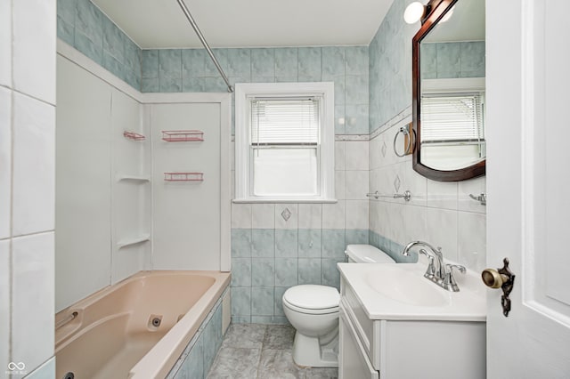 4621 E 17th St, Indianapolis, IN 46218 - bathroom with tile walls, vanity, toilet, and a combined bath / shower with jetted tub