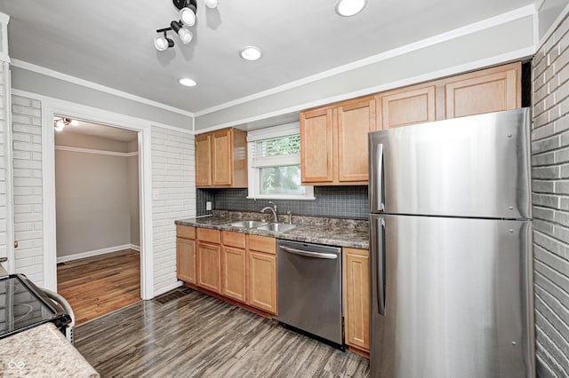 4621 E 17th St, Indianapolis, IN 46218 - kitchen with stainless steel appliances, a sink, dark wood finished floors, decorative backsplash, and crown molding