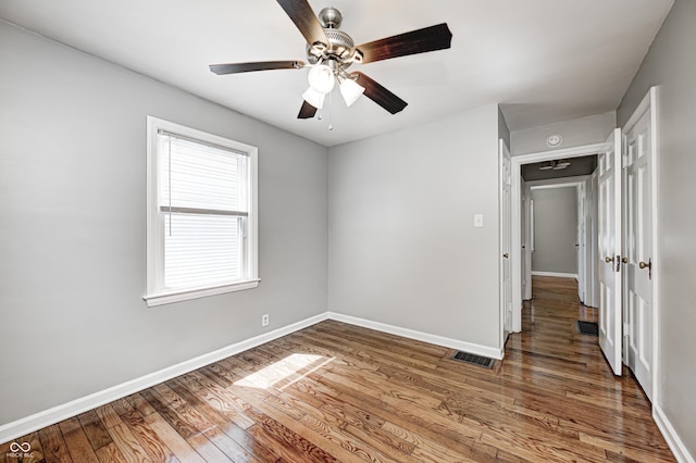 4621 E 17th St, Indianapolis, IN 46218 - unfurnished room with wood finished floors, baseboards, and a ceiling fan