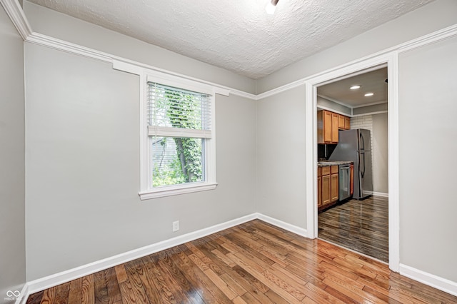 4621 E 17th St, Indianapolis, IN 46218 - empty room with light wood finished floors, baseboards, a textured ceiling, and recessed lighting