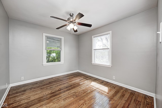 4621 E 17th St, Indianapolis, IN 46218 - empty room with healthy amount of natural light, dark wood-style flooring, and baseboards