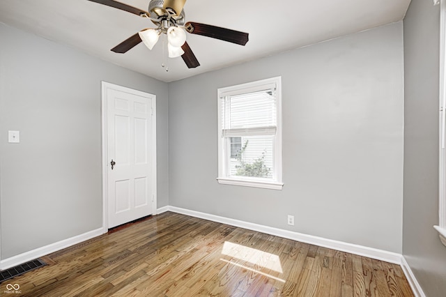 4621 E 17th St, Indianapolis, IN 46218 - empty room with baseboards, wood finished floors, and ceiling fan