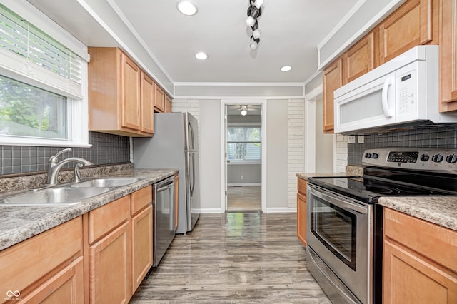 4621 E 17th St, Indianapolis, IN 46218 - kitchen featuring appliances with stainless steel finishes, a sink, decorative backsplash, baseboards, and recessed lighting