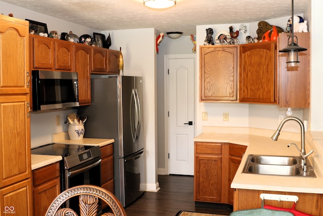 994 Youngs Creek Dr, Franklin, IN 46131 - kitchen with appliances with stainless steel finishes, a sink, light countertops, dark wood-style floors, and a textured ceiling