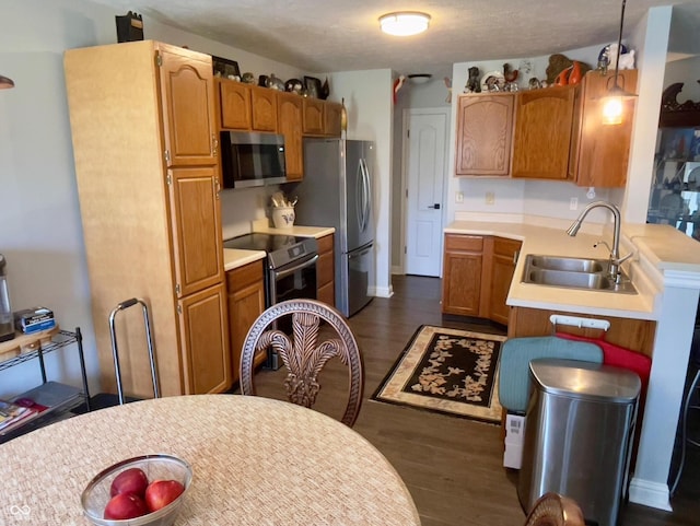 994 Youngs Creek Dr, Franklin, IN 46131 - kitchen featuring appliances with stainless steel finishes, a sink, light countertops, and dark wood-style floors