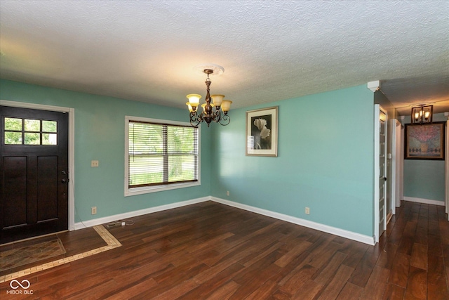 2519 N Boehning St, Indianapolis, IN 46219 - foyer with a chandelier, wood finished floors, baseboards, and a textured ceiling