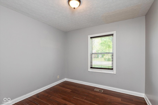 2519 N Boehning St, Indianapolis, IN 46219 - empty room with dark wood-style floors, baseboards, and a textured ceiling