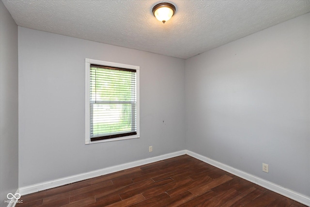 2519 N Boehning St, Indianapolis, IN 46219 - spare room featuring dark wood-type flooring, baseboards, and a textured ceiling