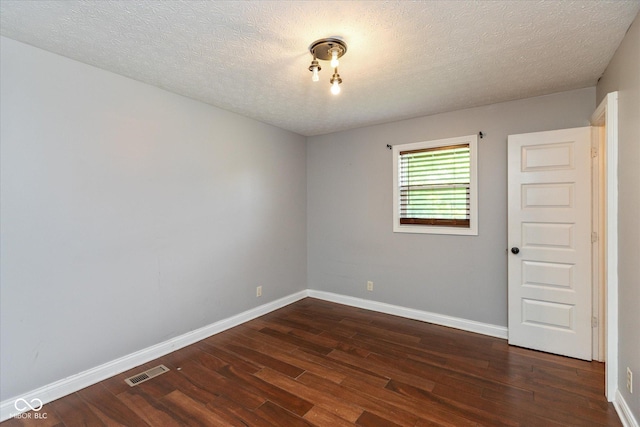 2519 N Boehning St, Indianapolis, IN 46219 - empty room with dark wood-style floors, baseboards, and a textured ceiling