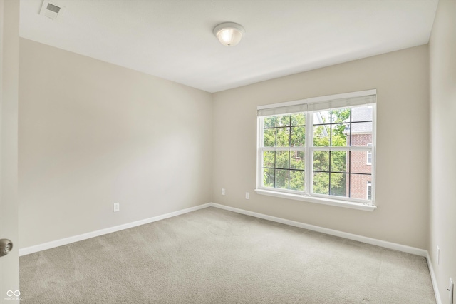 73 11th St NW, Carmel, IN 46032 - empty room featuring carpet flooring and baseboards