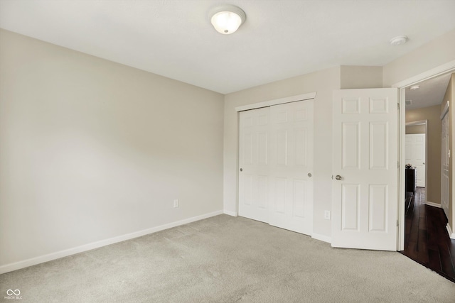 73 11th St NW, Carmel, IN 46032 - unfurnished bedroom with carpet flooring, baseboards, and a closet