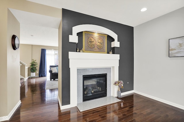 73 11th St NW, Carmel, IN 46032 - living room featuring wood-type flooring, a fireplace with flush hearth, baseboards, and recessed lighting