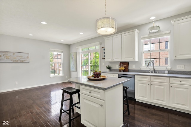 73 11th St NW, Carmel, IN 46032 - kitchen with dishwasher, a sink, a breakfast bar area, dark wood-style floors, and recessed lighting