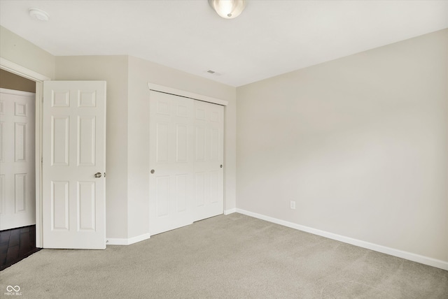73 11th St NW, Carmel, IN 46032 - unfurnished bedroom featuring light colored carpet, baseboards, and a closet