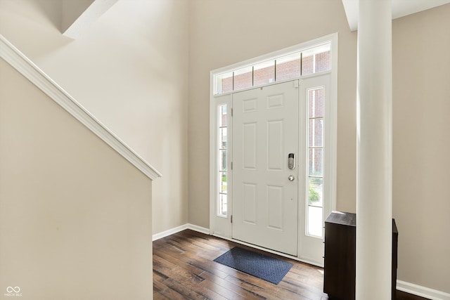 73 11th St NW, Carmel, IN 46032 - foyer with dark wood-type flooring, healthy amount of natural light, baseboards, and a high ceiling