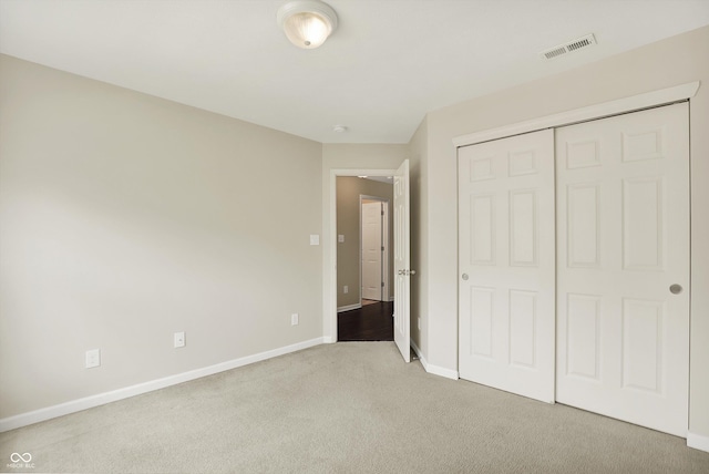 73 11th St NW, Carmel, IN 46032 - unfurnished bedroom featuring carpet floors, baseboards, and a closet