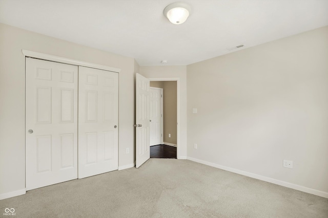 73 11th St NW, Carmel, IN 46032 - unfurnished bedroom featuring carpet flooring, baseboards, and a closet
