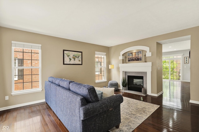 73 11th St NW, Carmel, IN 46032 - living area featuring dark wood-style flooring, a multi sided fireplace, and baseboards