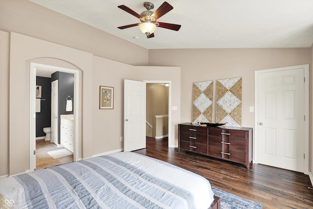 73 11th St NW, Carmel, IN 46032 - bedroom with lofted ceiling, dark wood-type flooring, baseboards, ceiling fan, and ensuite bathroom