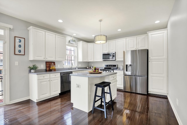 73 11th St NW, Carmel, IN 46032 - kitchen with appliances with stainless steel finishes, dark wood-style flooring, baseboards, white cabinetry, and recessed lighting