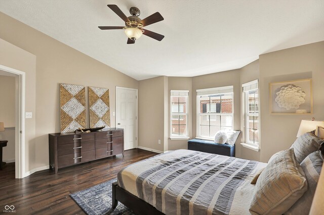 73 11th St NW, Carmel, IN 46032 - bedroom with dark wood-style flooring, baseboards, vaulted ceiling, and ceiling fan