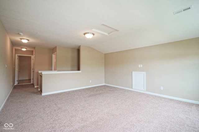 695 Overcup St, Westfield, IN 46074 - unfurnished room featuring attic access, light carpet, baseboards, and vaulted ceiling