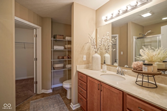 695 Overcup St, Westfield, IN 46074 - bathroom featuring vanity, a shower stall, a walk in closet, and toilet