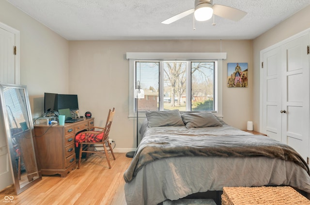 249 Spring St, Plainfield, IN 46168 - bedroom featuring light wood finished floors, a textured ceiling, baseboards, and a ceiling fan