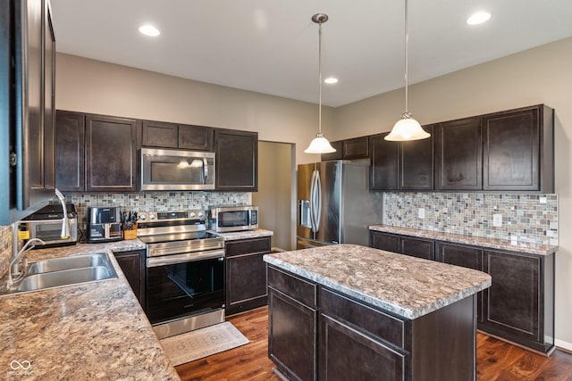 2626 Solidago Dr, Plainfield, IN 46168 - kitchen with appliances with stainless steel finishes, a sink, dark brown cabinetry, tasteful backsplash, and recessed lighting