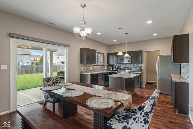 2626 Solidago Dr, Plainfield, IN 46168 - dining area featuring healthy amount of natural light, dark wood-style flooring, a chandelier, and recessed lighting
