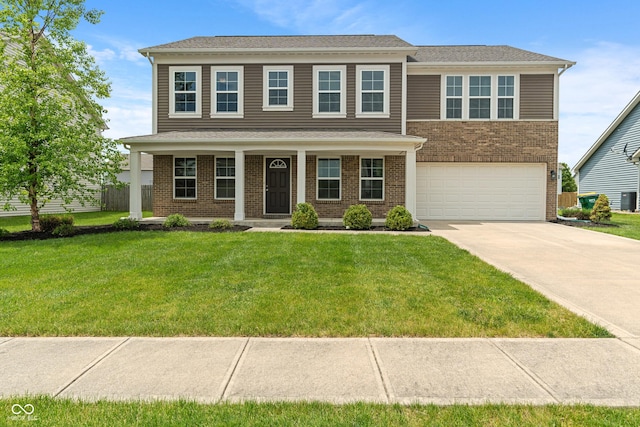 2626 Solidago Dr, Plainfield, IN 46168 - view of front facade with a garage, concrete driveway, brick siding, and a front yard