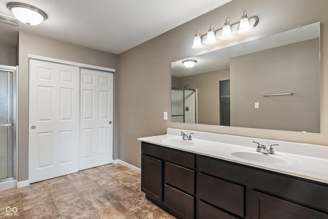 2626 Solidago Dr, Plainfield, IN 46168 - bathroom with baseboards, double vanity, a shower stall, and a closet