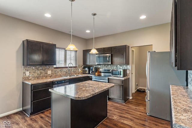 2626 Solidago Dr, Plainfield, IN 46168 - kitchen featuring stainless steel appliances, a sink, tasteful backsplash, dark wood finished floors, and a center island