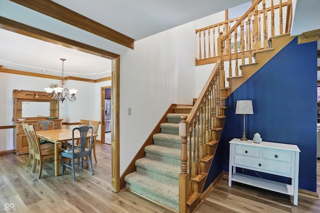 12335 Old Stone Dr, Indianapolis, IN 46236 - staircase with wood finished floors, a chandelier, crown molding, and baseboards