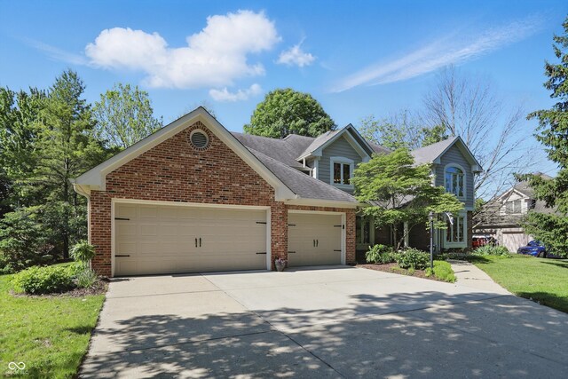 12335 Old Stone Dr, Indianapolis, IN 46236 - traditional home with brick siding, concrete driveway, an attached garage, and roof with shingles