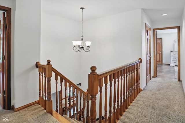 12335 Old Stone Dr, Indianapolis, IN 46236 - hallway featuring an upstairs landing, carpet flooring, a chandelier, baseboards, and recessed lighting