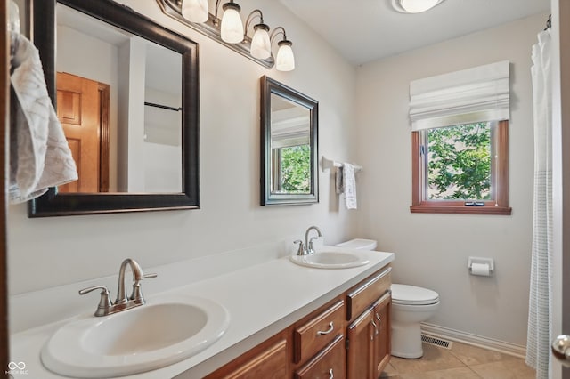 12335 Old Stone Dr, Indianapolis, IN 46236 - full bathroom featuring healthy amount of natural light, double vanity, toilet, and tile patterned flooring