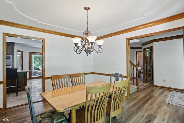12335 Old Stone Dr, Indianapolis, IN 46236 - dining space with a chandelier, wood finished floors, and stairway