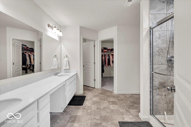 13495 Forest Glade Dr, Fishers, IN 46037 - full bathroom with double vanity, a walk in closet, a stall shower, and baseboards