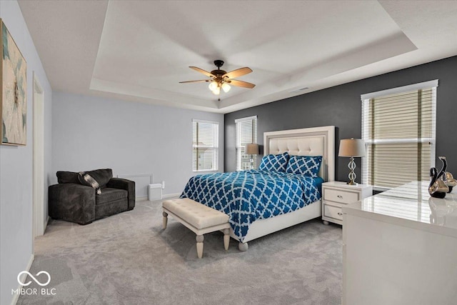13495 Forest Glade Dr, Fishers, IN 46037 - bedroom featuring a raised ceiling, light colored carpet, baseboards, and a ceiling fan