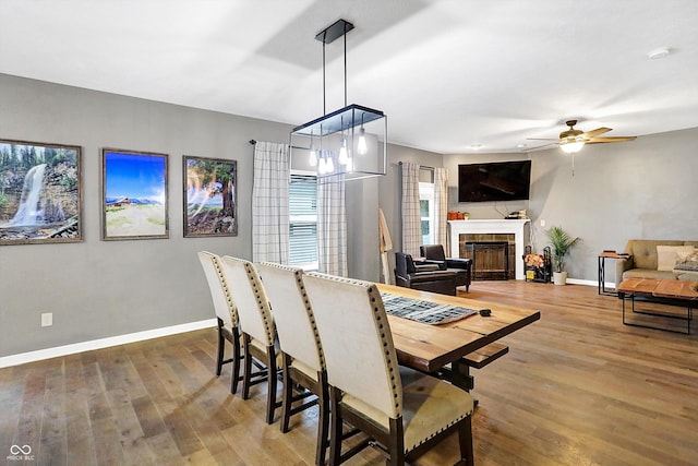 1664 Woodside Cir, Franklin, IN 46131 - dining room with wood finished floors, ceiling fan, and a tile fireplace