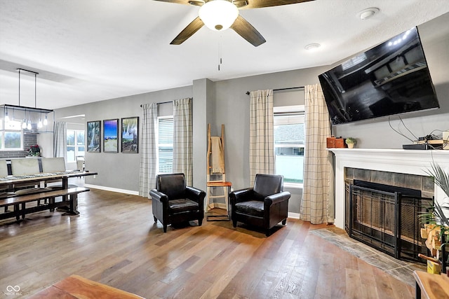 1664 Woodside Cir, Franklin, IN 46131 - living area featuring plenty of natural light, wood finished floors, a ceiling fan, and a fireplace