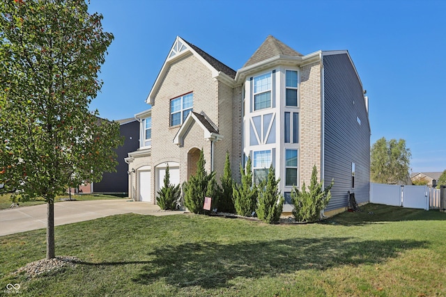 1664 Woodside Cir, Franklin, IN 46131 - view of front facade featuring driveway, a garage, a gate, and brick siding