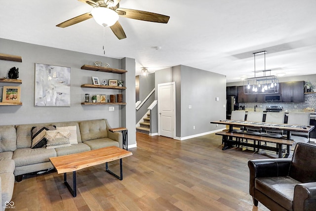 1664 Woodside Cir, Franklin, IN 46131 - living area featuring stairway, a ceiling fan, and wood finished floors